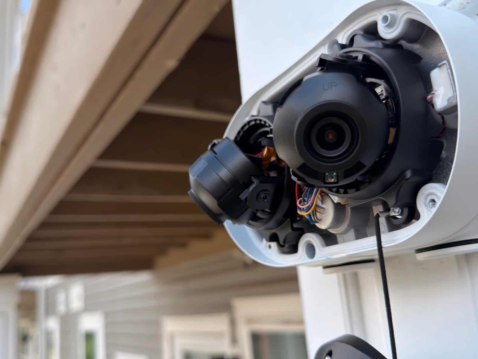 Multi-sensor dome camera mounted under a soffit with the cover off during installation